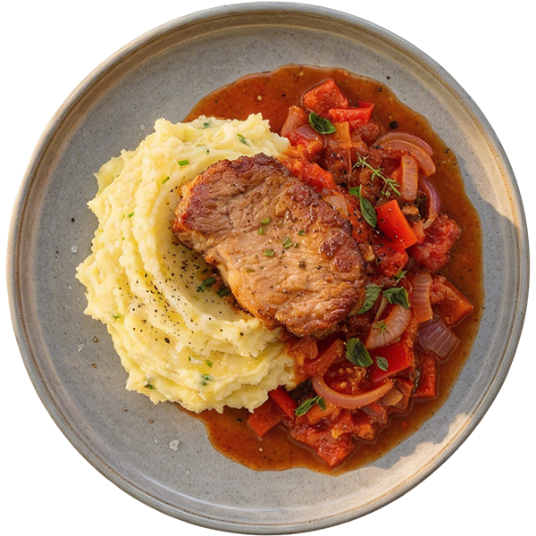 Pork chop in onion and pepper sauce with mashed potatoes