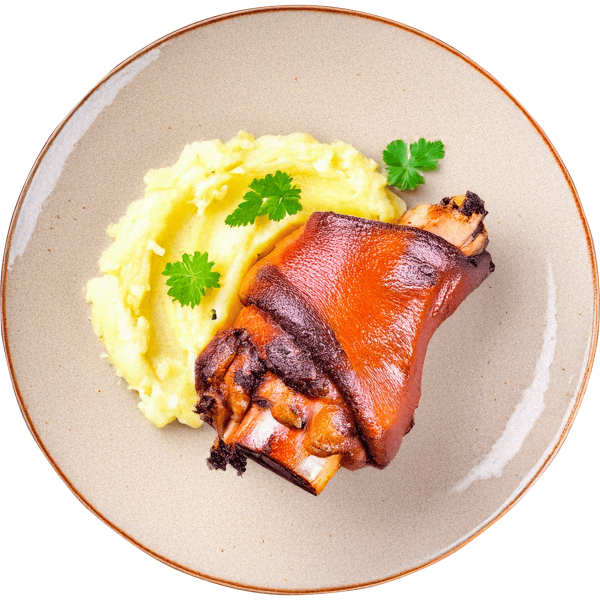 Roasted knuckle with mashed potatoes in roasting gravy